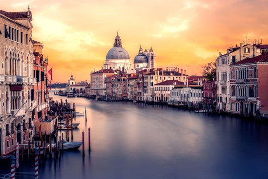 Venice cityscape with Grand Canal and Basilica di Santa Maria della Salute at sunset.